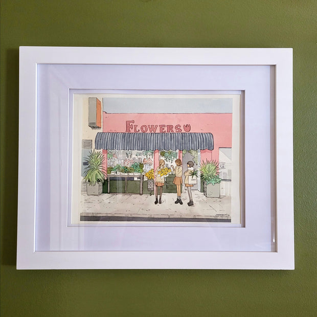 Ink and watercolor illustration of a flower shop exterior, with 3 girls standing in front of it in matching outfits. One holds a bouquet of yellow flowers and the other has a green plant in her bag. Piece is matted into a white frame.