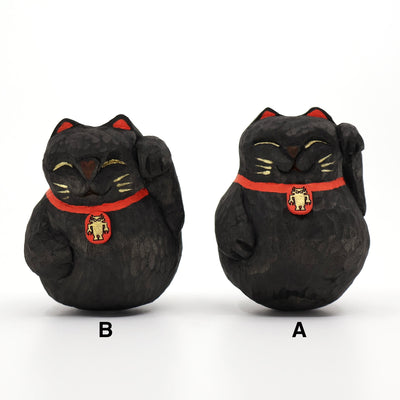 2 rounded whittled wooden sculpture of black maneki cats, smiling with closed eyes and one paw raised. They have gold whiskers and eyelids and wear a red collar with a gold Big Boss Robot on it. Labeled A and B.