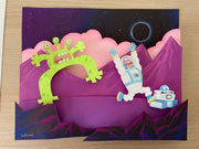 Assembled paper cutting of a illustrative style astronaut and small robot running away comically from a green alien, who appears also startled. Space background is purple and pink.