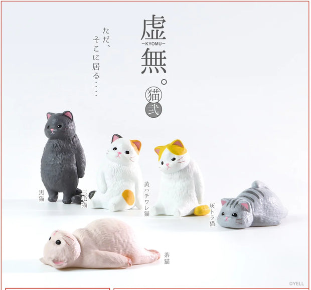 5 small cat figurines, each standing or laying and looking off blankly, as if staring off into the void.