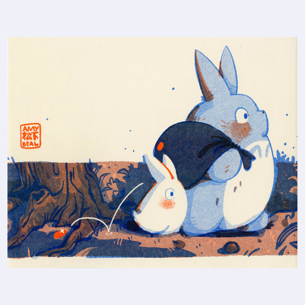 Risograph print of a small blue and white chibi Totoro from My Neighbor Totoro. One holds a knapsack and the other trails nearby. A small red shiny object drops out of the sack.