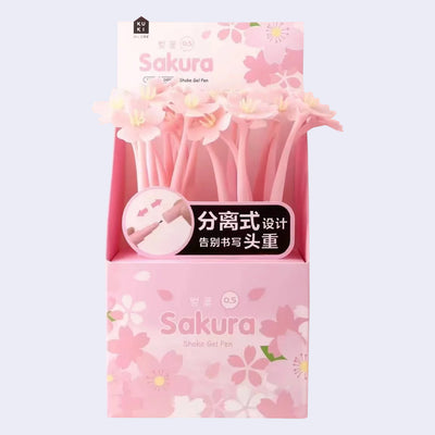 Product packaging of many pink rubber bodied pens with cherry blossom tops.