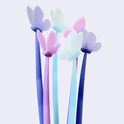 Several pens with butterflies at the top of them. Colors are blue, purple and pink.