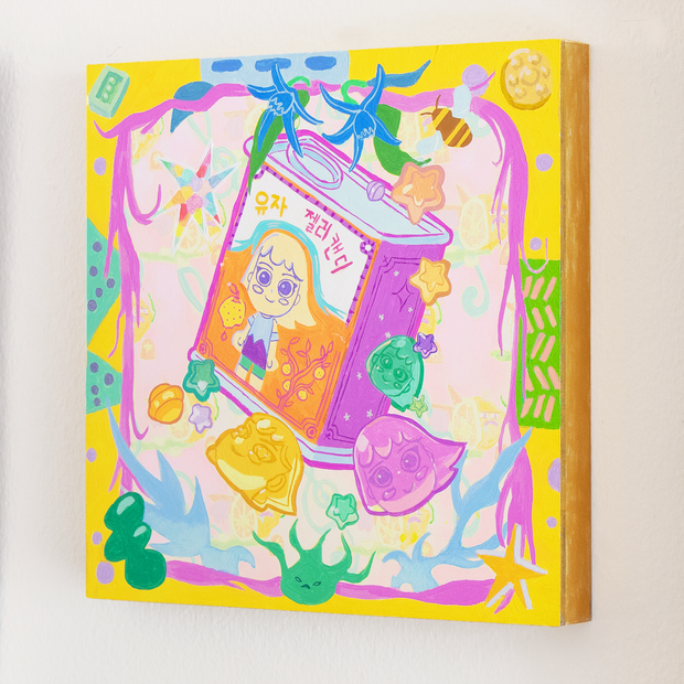 Colorful painting of a tin can of lemon drop candy, with a girl on the product packaging. Various shaped hard candy is nearby and the piece is framed by yellow abstract framing.