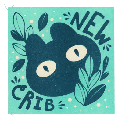Mini zine with a teal cover featuring a simple illustration of a cat with leaves and text that says "new crib"