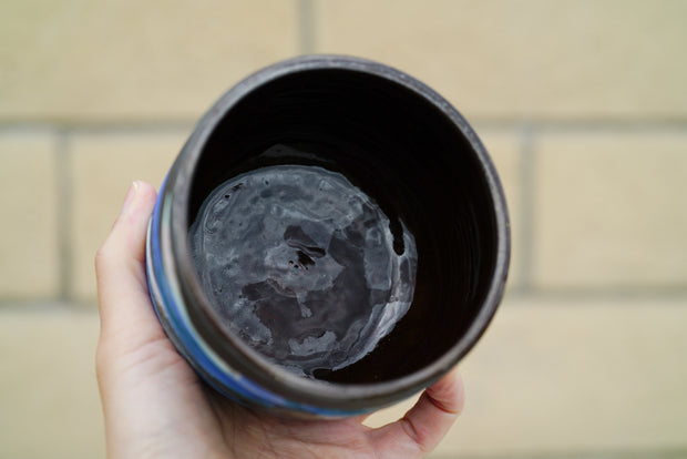 Inside view of black ceramic cup with glazed inside.