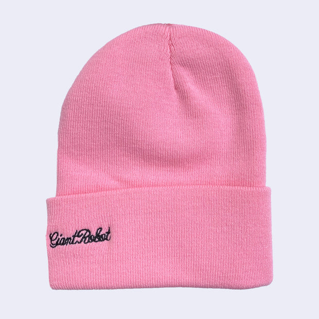 A bright pink knit beanie with "Giant Robot" written along the side in cursive.