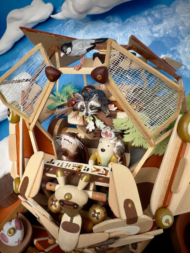 Very intricate sculpture of a robot made out of small wooden parts, resembling a cat or a dog. It is being piloted by small characters with smaller animals all over the robot.