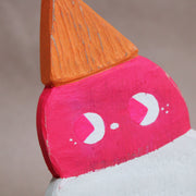 Die cut painted wooden sculpture of an upside down double scoop ice cream cone. One scoop is pink and the other is white, they both have cute drawn on faces looking off to the side.