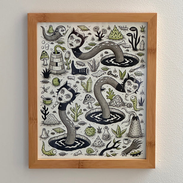 Pattern style illustration on cream paper of several cat head serpent creatures popping out of black holes from the ground. Around them are various fantasy trope objects, such as potions, herbs, crystals, keys and notes. Framed in wooden frame.