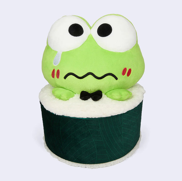 Plush doll of Sanrio's Keroppi, a cute green frog, with large eyes and a worried expression. He's inside a sushi roll, with just his head and small hands popping out. He sheds a single tear and wears a black bowtie.