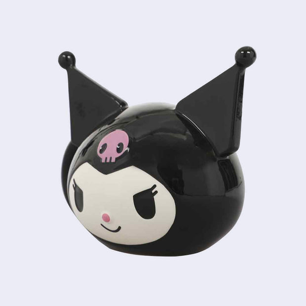 Ceramic mug of Kuromi's head, with her pointed ears sculpted off of the mug. A handle comes off the side of her head. Side angle.