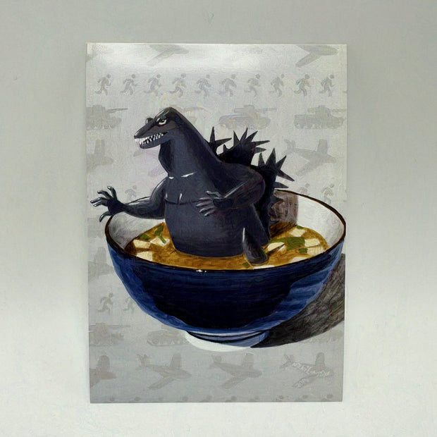 Illustration of a cartoon Godzilla in a bowl of miso soup.