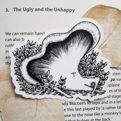 Black and white sticker of an oyster mushroom with a small cartoon face, lounging in grass.