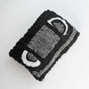 Small crocheted VHS tape.