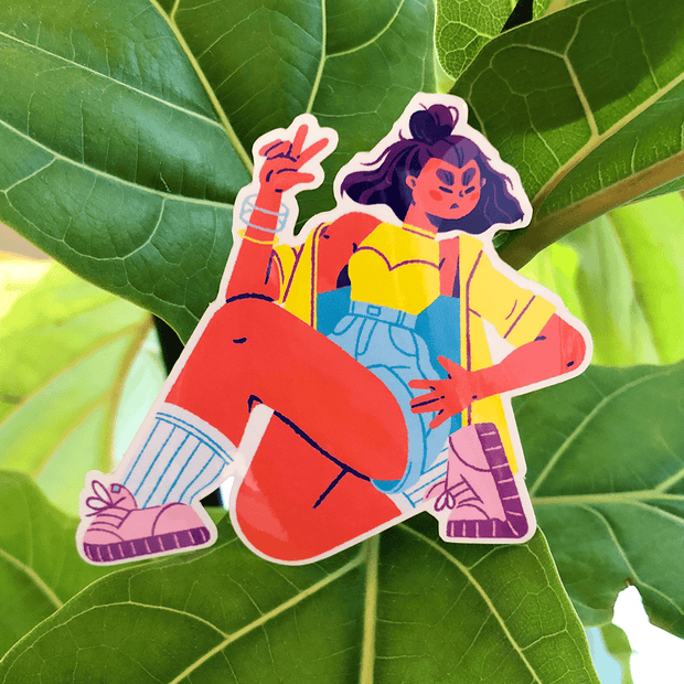 Die cut sticker of a girl down on one knee with her hand on her waist and the other hand throwing up a peace sign.