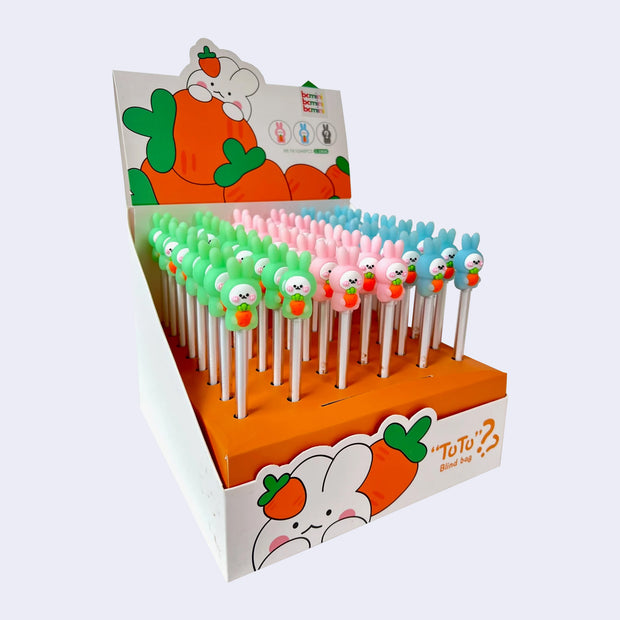 Display of 48 pens with plastic toppers of rabbits holding a carrot to its stomach.