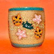 Earthenware ceramic pot with cartoon style illustrations of a tiger on the front, decorated with small robot heads and cherry blossoms.