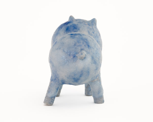 Small blue and white splotched ceramic sculpture of a character made up of 2 spheres attached together, with 4 legs and small ears and eyes.