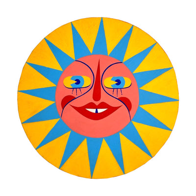 Die cut painted wooden circle, yellow with a pink sun face in the center. It has large eyes and red nose and lips. It emits sharp blue rays.