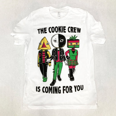 White t-shirth with an illustration of 3 popular Jewish bakery cookies, with human bodies dress in a punk style. Text reads "The cookie crew is coming for you"