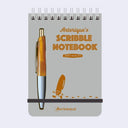 Scribble notebook with pen holder and 'Anterique's Scribble Notebook' text on a light gray background