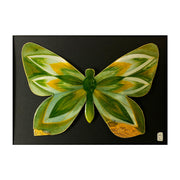 Illustration on cut out paper of a butterfly with gold and deep green wings, with abstract wing patterns akin to pointed leaves. Butterfly is outlined in gold with gold leaf on parts of the wing. It is mounted on black paper.
