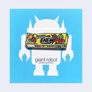 Die cut enamel pin of a sleeve of Hi-Chew candy in yellow product packaging, with the design slightly edited. The front says "Hello Chew" and has a small graphic of a robot head, along with "giant robot" written in lowercase in bottom right corner. On blue backing card.
