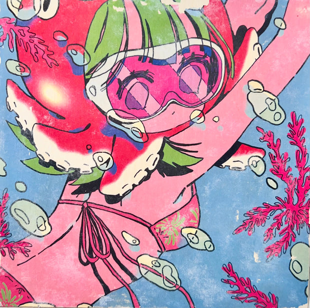 Image transfer onto wood of an illustrated girl in a bikini, swimming underwater with goggles and a red octopus around her head, like a hat. Bubbles and coral are all around.