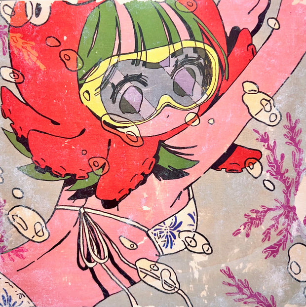 Image transfer onto wood of an illustrated girl in a bikini, swimming underwater with goggles and a red octopus around her head, like a hat. Bubbles and coral are all around.