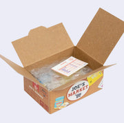 Open box of miniature stickers, made to resemble a shipping box with bubble wrap around the product and a small invoice. Exterior of box looks like realistic Trader Joe's imitation grocery box.