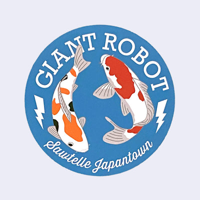 Blue circular sticker of 2 koi fish, swimming in a circle. Around them, reads "Giant Robot" above and "Sawtelle Japantown" below.