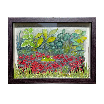 Ink and watercolor drawing of a frog peeping out of the water of a cranberry bog, with a single cranberry atop its head and many around it, with leaves and greenery behind it. In front of the piece is cut out grass, creating a shadow box style display.