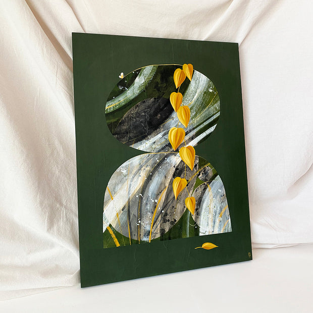 Collage style painting on solid dark green background of 2 rocks stacked atop of one another. Rocks contain a very bold abstract grey and green marble patterning. In front of the rocks is a vine of yellow Pothos leaves. Displayed at an angle.