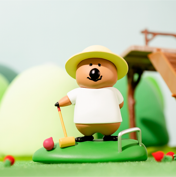 Vinyl figure of a cartoon quokka, wearing a sun hat and white shirt and playing croquet. 