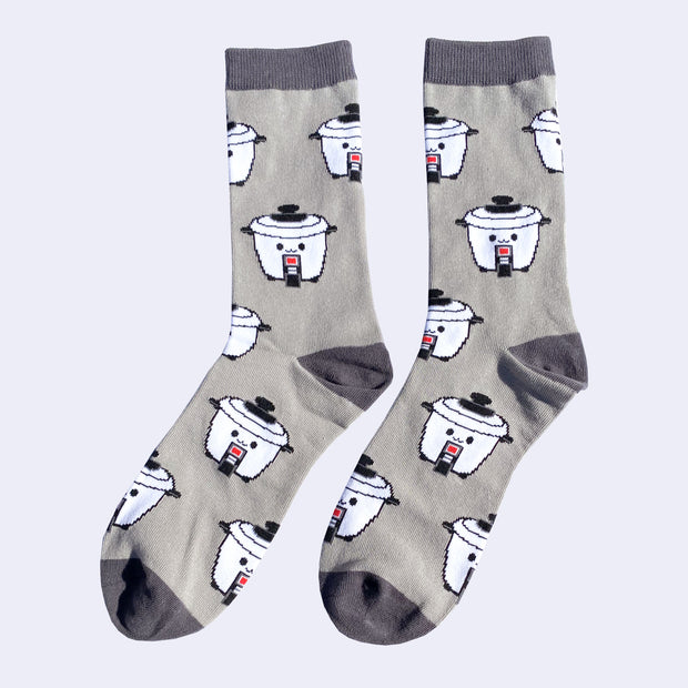 Gray socks with dark grey top, heels and toes. A repeating pattern of a cute cartoon rice cooker is on the socks.