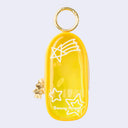 Yellow clear colored oval shaped pouch attached to a keychain, with gold keychain hardware and a small golden Sonny Angel on the side. White line doodles decorate the exterior.