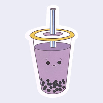 Die cut sticker of a taro boba cup with a small smiling cartoon style face in the center of the cup.