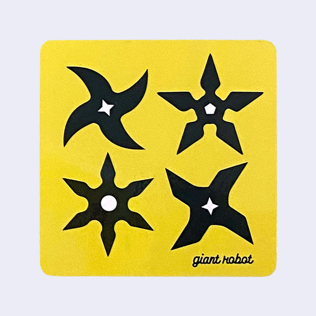 Yellow square sticker with rounded edges featuring 4 differently shaped ninja stars, a simple black silhouette with white centers. "Giant Robot" is written in small black cursive in lower right corner.
