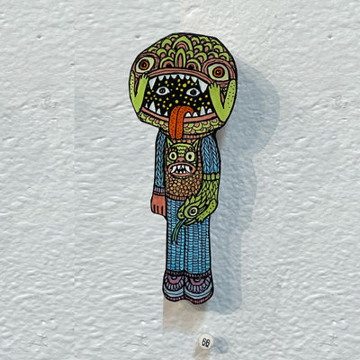 Illustrated wood cut of a space faced creature wearing a monster hat.
