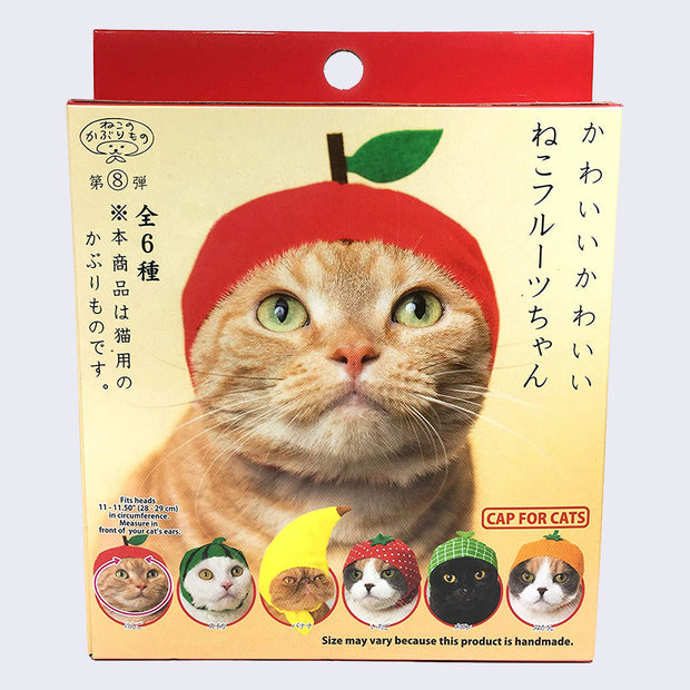 A red and yellow blind box packaging, with a tabby cat wearing a snug cap resembling an apple, with a stem and green leaf protruding from the top. 6 designs show at the bottom the the box, including apple, watermelon, banana, strawberry, melon and orange. Japanese script is on the box.