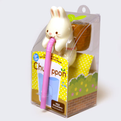 White rabbit planter, with its mouth connected to a pink drinking straw and a small brown pot on its back, where herbs can grown.