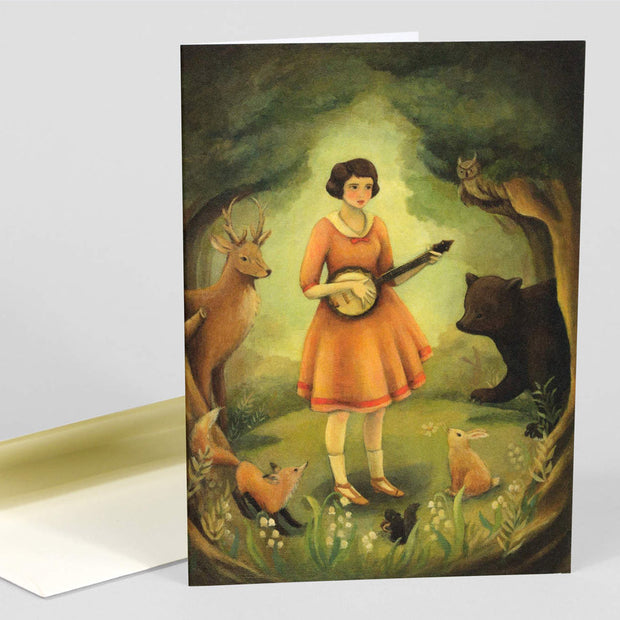 The front of note card is shown The notecard has an illustration of a girl playing the banjo to an audience of forest animals.