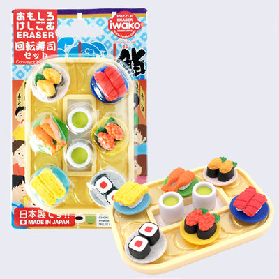 Set of small erasers made to look like sushi on little plates going around a conveyor belt.