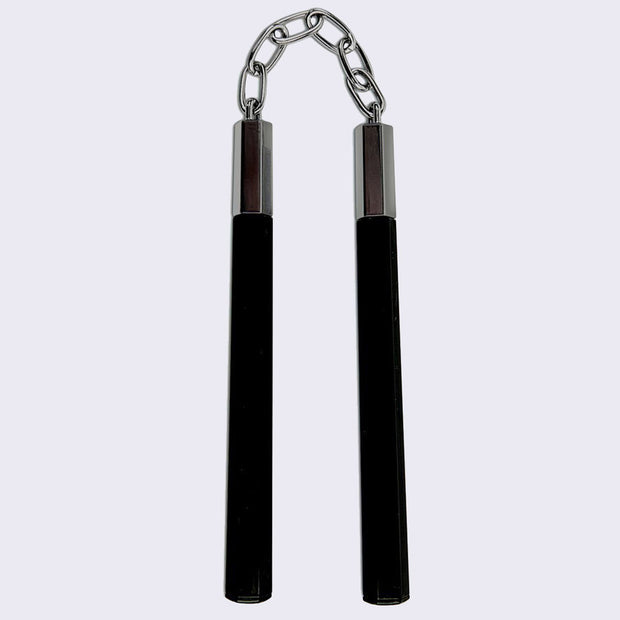 Black pen with a chain attached to its cap, which connects it to another pen such as a nunchuck.