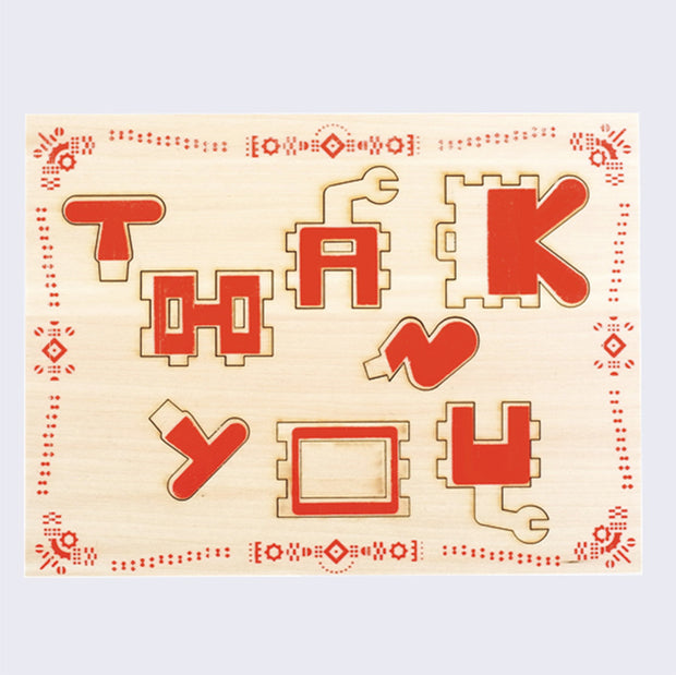 Wood card with stylized text that says thank you. A wavy red border along edges mimics morse code messaging but made to look like flowers.