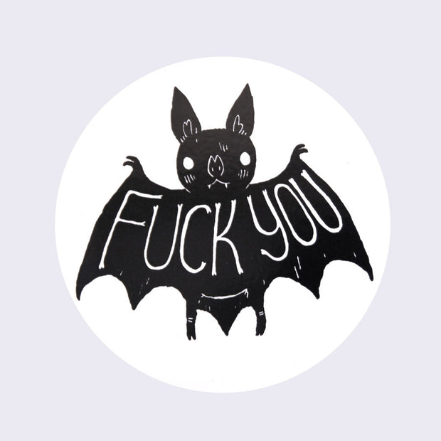 White circle sticker with a drawing of a cute cartoon bat. Large text stretches across its wings that says fuck you.