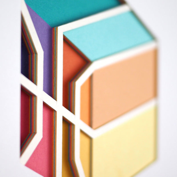 Flat sculpture made out of multiple layers of colorful cut paper, displaying a square basketball.