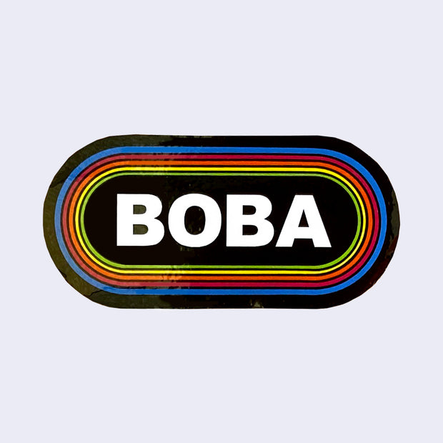 Rounded corner rectangle sticker, black with the word "Boba" written in bold, all caps white font in the center. It is surrounded by 6 thin lined borders, each a different color of the rainbow.