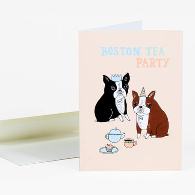 Light pink greeting card of 2 illustrated Boston Terriers sitting on the ground wearing fancy attire with tea and a cupcake. Text reads "Boston Tea Party"
